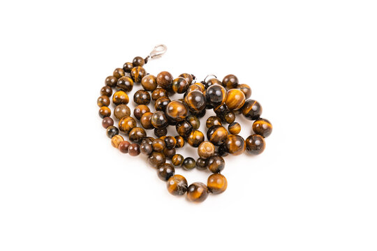 Tiger eye stone beads on a white background