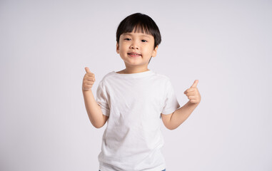 Portrait of an Asian boy posing on the white background