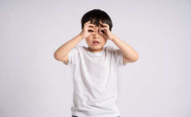 Portrait of an Asian boy posing on the white background