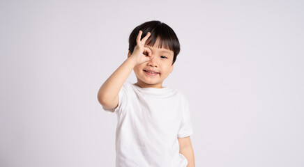 Portrait of an Asian boy posing on the white background