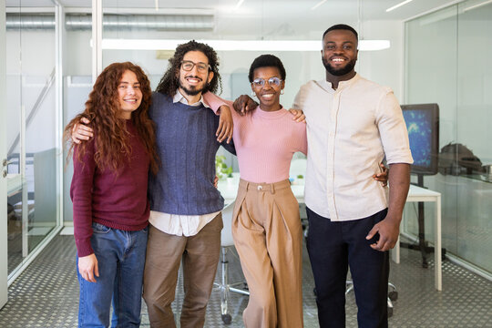 Diverse group of professionals smiling together in an office