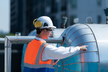Engineers inspect the completed air conditioning and water systems to continue verifying their...