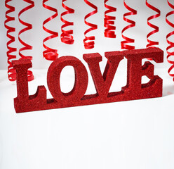 Red ribbon and word love over isolated white background - 774039466
