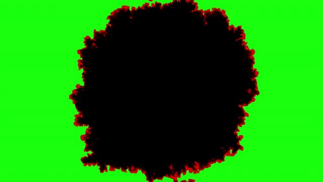 Black spot burning from the center. Smoldering paper spreads, video transition isolated on green screen