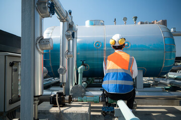 Engineers inspect the completed air conditioning and water systems to continue verifying their...
