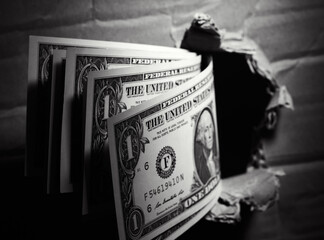 one dollar bills through the paper hole money background. Bribe concept