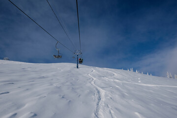 Fototapeta na wymiar sunny winter morning in the mountains of sheregesh on the ski track.