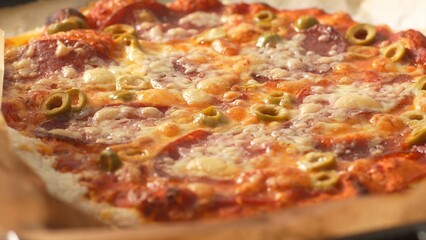 Bubbling Homemade Pizza with Pepperoni and Olives right out of the oven. Close-up, shallow dof.