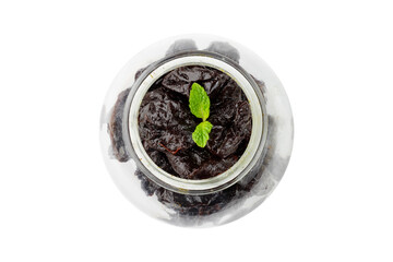 Dried plum in a glass bowl isolated on a white background top view