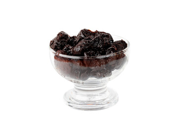 Dried plum in a glass bowl isolated on a white background front view