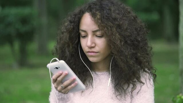 woman calling someone using cell phone with earphone: teenager with smartphone