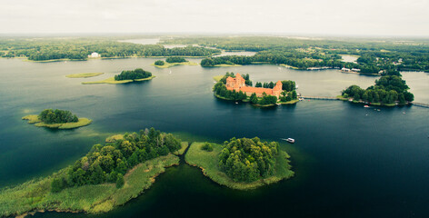 Scenic Lithuanian famous Trakai castle aerial view and islands in overcast day in summer.Historical...