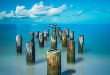 Wooden posts on Naples Beach, Florida - Powered by Adobe