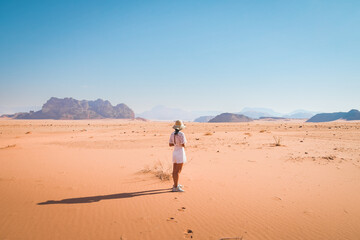 Back view female tourist stand curious watch wadi rum desert landscape panorama of Jordan countryside