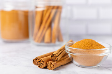 Ceylon cinnamon.Cinnamon sticks on a textured wooden background. Cinnamon roll and powder. Spicy spice for baking, desserts and drinks. Fragrant ground cinnamon. Close-up. Place for text. copy space