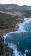 Rough sea in Sardinia near Porto Flavia. Aerial view of Pan di Zucchero and crystal clear sea