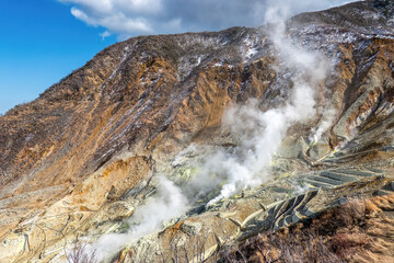 Active sulphur vents at Ōwakudani volcanic valley in Hakone, Kanagawa Prefecture, Japan. Steaming sulfur field and industrial sulfur mining near Mount Fuji.