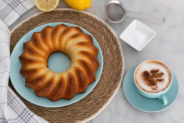 Delicious lemon sponge cake with a cappuccino. Food concept.