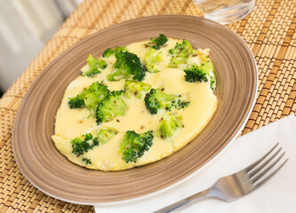 wholesome breakfast. omelet with broccoli on brown plate