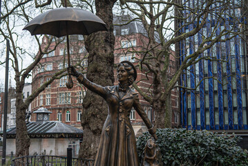 The statue of Merry Poppins  holding an umbrella in London, UK