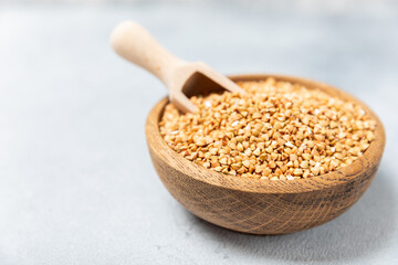 Green buckwheatin  on a wooden kitchen table.Superfood.Raw buckwheat porridge.Healthy vegan food concept, eco products, diet. Copy space.Organic food.weight loss and proper nutrition.