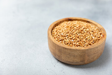 Green buckwheatin  on a wooden kitchen table.Superfood.Raw buckwheat porridge.Healthy vegan food concept, eco products, diet. Copy space.Organic food.weight loss and proper nutrition.