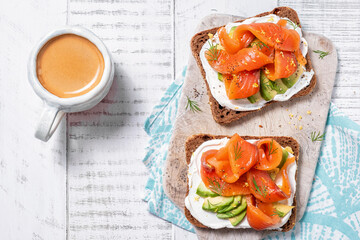 Two open sandwich, toast with salmon, cream cheese, avocado