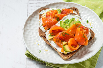 Two open sandwich, toast with salmon, cream cheese, avocado