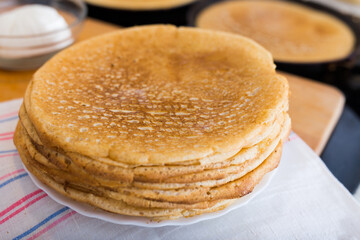 cooking traditional pancakes from wheat flour in the kitchen