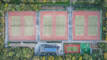 Aerial top view of a dry tennis court in a park