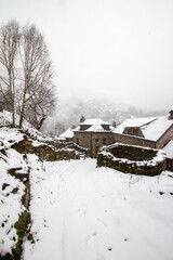 an old stone barn in a beautiful snowy mountain village