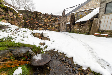 snowy stone streets and buildings in a picturesque town in the Spanish province of León, called...