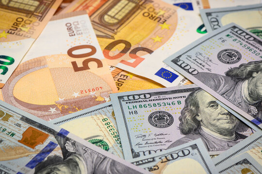 Money, Dollar and Euro. One hundred US dollar banknote over Euro banknotes. Foreign exchange market concept.1