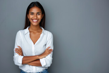 Confident Young Businesswoman Smiling with Arms Crossed