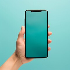 Female hand holding smartphone with blank screen on turquoise background.