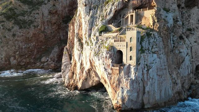 Rough sea in Sardinia near Porto Flavia. Aerial view of Pan di Zucchero and crystal clear sea