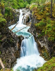 Fototapeta na wymiar Vertical shot of a waterfall in Little Qualicum Falls Provincial Park