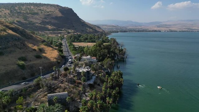 Aerial view of a mountain road with passing cars and the Sea of Galilee. Tiberias, Israel.