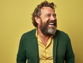 A man with a bright color clothing is smiling and laughing