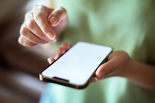 Top view of woman holding smartphone with blank screen