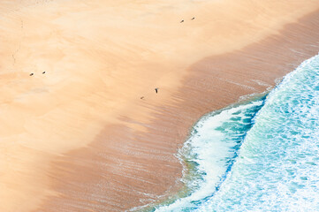 Atlantic ocean coast in Algarve, Portugal. Turquoise water and yellow sand.
