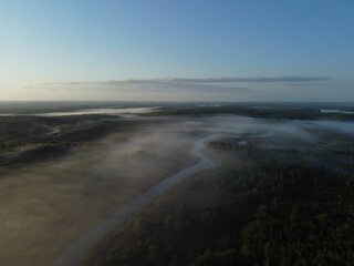 Aerial foggy view of the river and forest