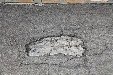 Road pothole in Italy. Damaged road surface with potholes. - 774091475