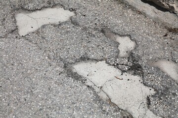 Road holes in Greece. Damaged road surface with potholes. - 774091643