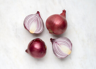 Red onion and cut in half sliced on white marble background top view - 774092606