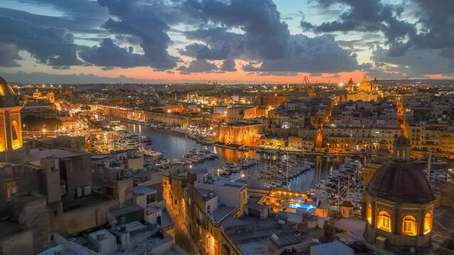 Epic evening shot of old town with churches and marina with yacht in Malta. Aerial sunset view of three cities - Vittoriosa, Senglea and Cospicua - Malta. HDR 4K