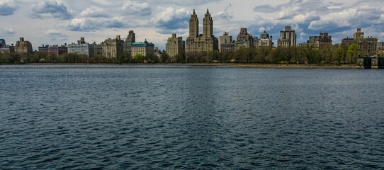 Panoramic view of luxury buildings overlooking the Jacqueline Onassis Reservoir in Central Park