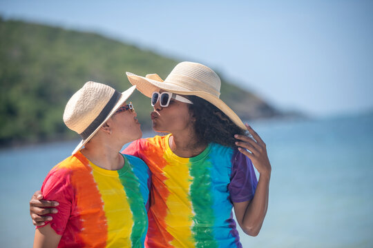 Romantic happiness couple LGBTQ wearing sunglass and hat lover just kiss big hug giving happiness with equality freedom of love friendship and LGBTQ couple is relax summer holidays concept.