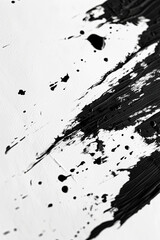 Obraz premium Black ink splashes on a white paper