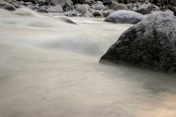 Landsape of frozen lake with snowy rocks in the winter